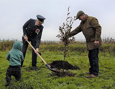 Group Captain Mike Trace OBE DL planting the tree